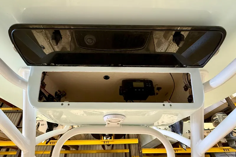 Slide: The Image of View of a Key West 219 FS boat's T-top with built-in storage compartment. - 22