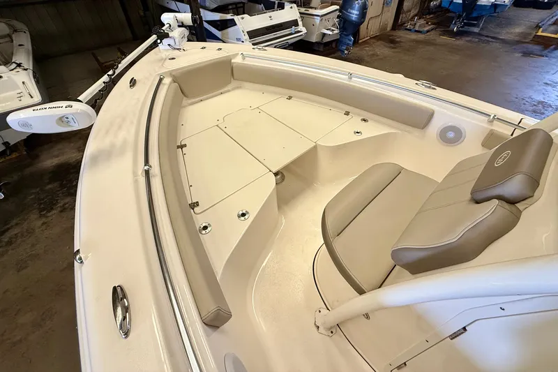 Slide: The Image of The image shows the bow area of a 2023 Key West 219 FS boat with beige upholstery. - 11