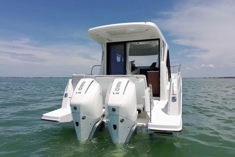 Slide: The Image of 2026 Beneteau Antares 9 V2 with twin outboard engines on calm sea. - 12
