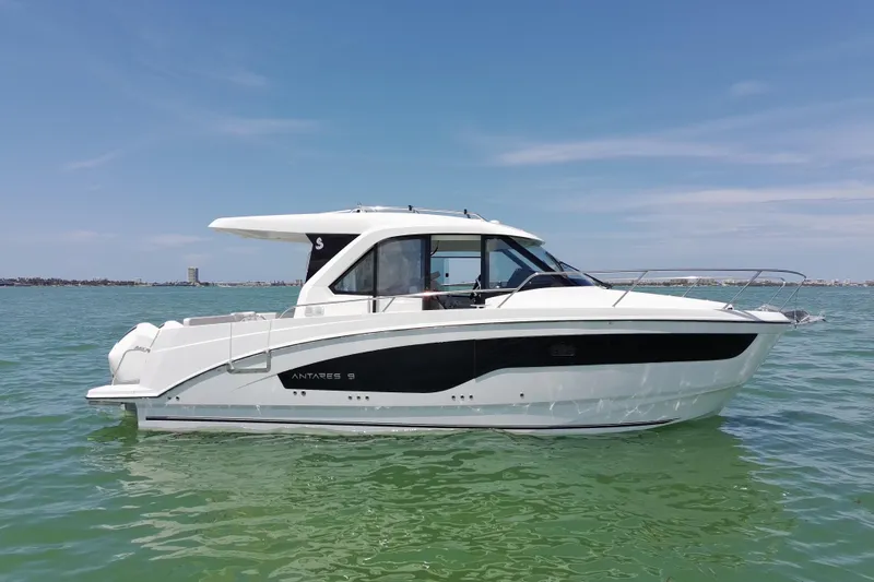 The Image of 2026 Beneteau Antares 9 V2 boat on calm water under clear blue sky. - 3