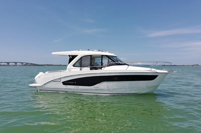 Slide: The Image of 2026 Beneteau Antares 9 V2 boat on calm water under clear blue sky. - 4