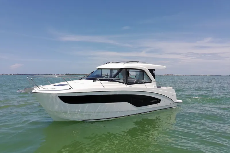 Slide: The Image of 2026 Beneteau Antares 9 V2 boat on calm sea under clear blue sky. - 9