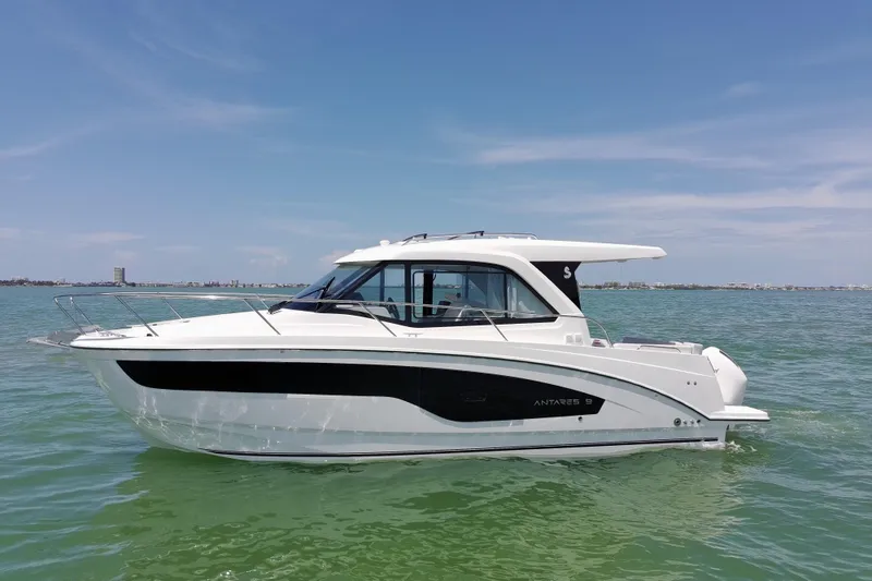 Slide: The Image of 2026 Beneteau Antares 9 V2 boat on calm water under clear sky. - 8