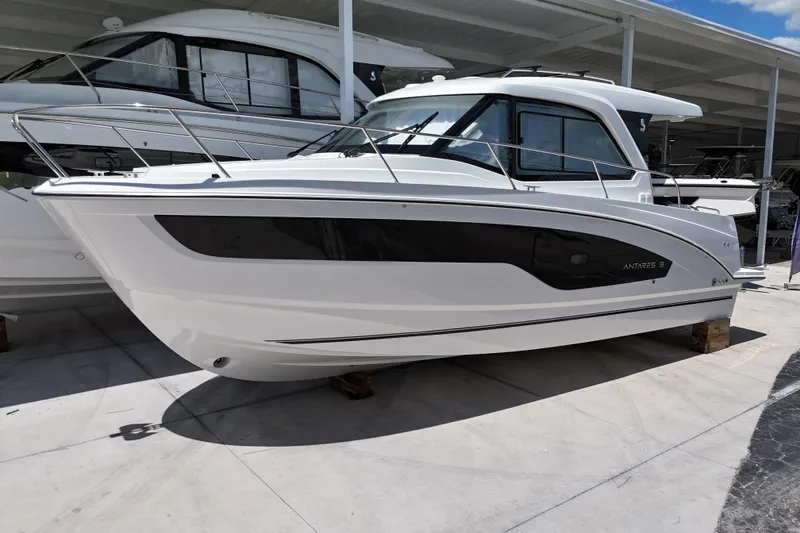 Slide: The Image of 2026 Beneteau Antares 9 V2 boat displayed in a showroom, side view. - 0