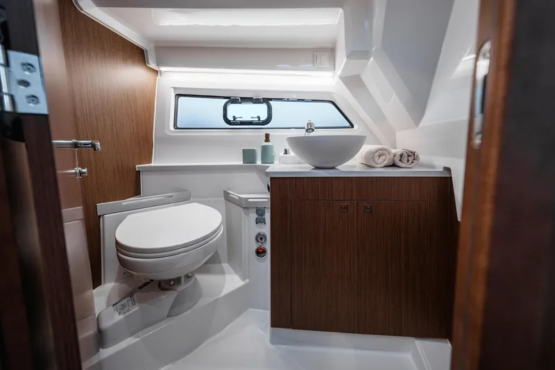 Slide: The Image of Modern bathroom in 2026 Beneteau Antares 9 V2 yacht with sleek design and wood accents. - 34