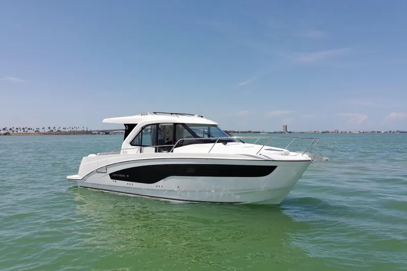Slide: The Image of 2026 Beneteau Antares 9 V2 boat on calm water under clear blue sky. - 5