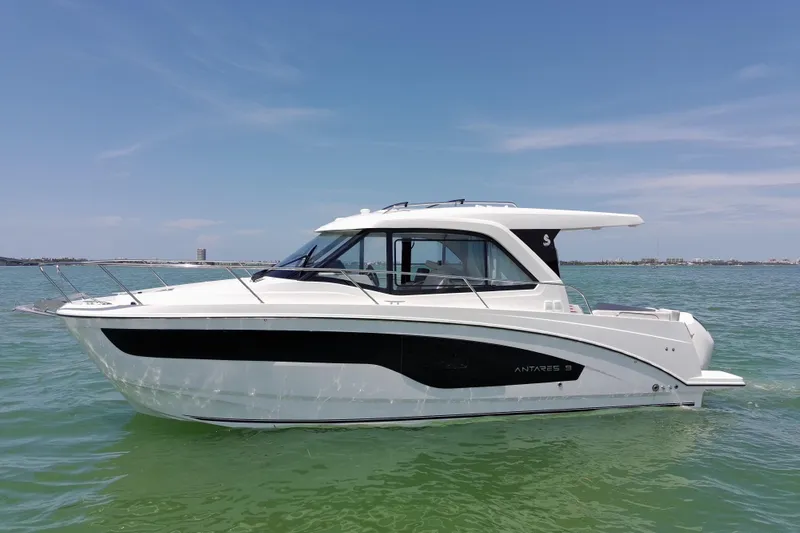 Slide: The Image of 2026 Beneteau Antares 9 V2 boat on calm water under clear blue sky. - 7