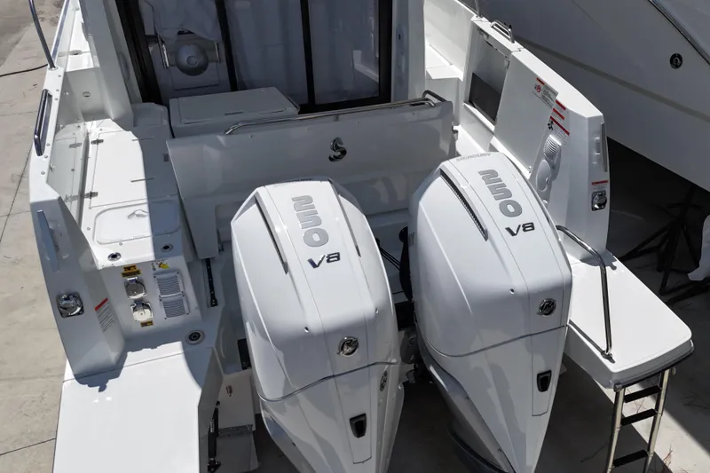 Slide: The Image of 2026 Beneteau Antares 9 V2 with dual Mercury 250 V8 engines, rear view. - 2