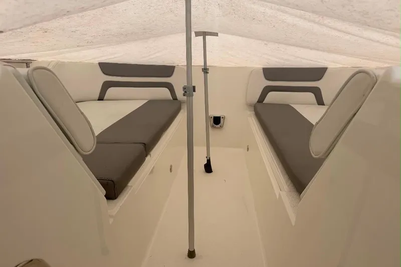 Slide: The Image of Interior view of 2019 World Cat 320 DC boat cabin with cushioned seating. - 14