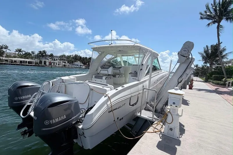 Slide: The Image of 2019 World Cat 320 DC boat docked with Yamaha engines, under a sunny sky. - 8