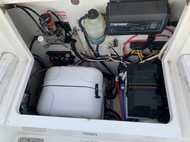 Slide: The Image of A view of the engine compartment of a 2019 World Cat 320 DC with various technical components. - 32