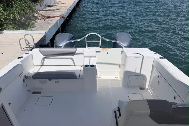 Slide: The Image of 2019 World Cat 320 DC boat interior with seating, docked by the water. - 31
