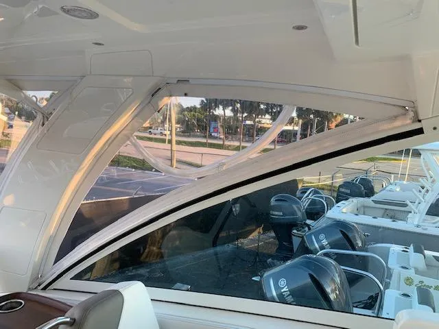 Slide: The Image of Interior view of a 2019 World Cat 320 DC with clear windows and multiple outboard engines. - 17