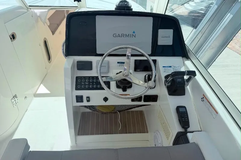 Slide: The Image of Cockpit of 2019 World Cat 320 DC boat with Garmin navigation system. - 21