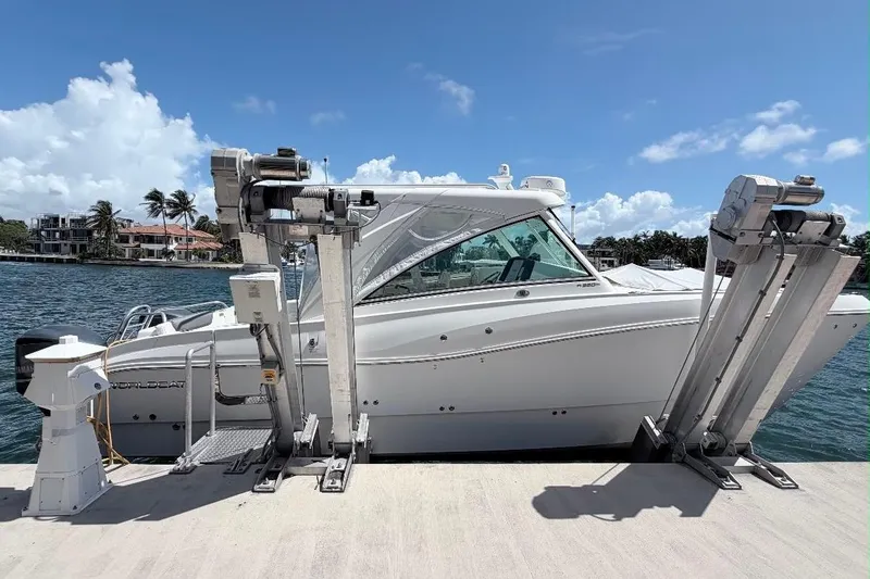 Slide: The Image of 2019 World Cat 320 DC boat docked by the waterfront under a clear blue sky. - 7