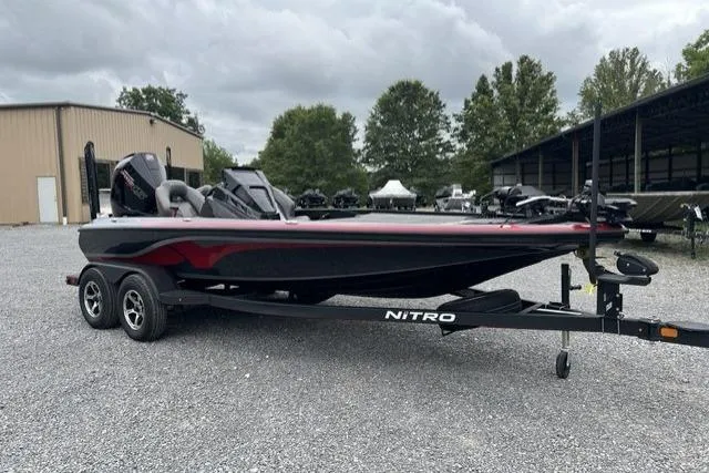 Slide: The Image of 2024 Nitro Z19 boat on trailer, parked outdoors, overcast sky. - 9
