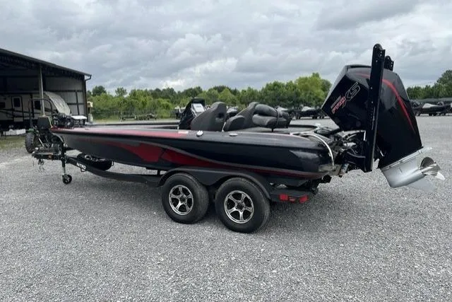 Slide: The Image of 2024 Nitro Z19 boat with dual-axle trailer, parked outdoors on gravel. - 7