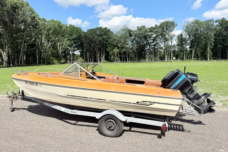 The Image of 1978 Arrow Glass Cheetah boat on trailer, parked outdoors with trees in background. - 1