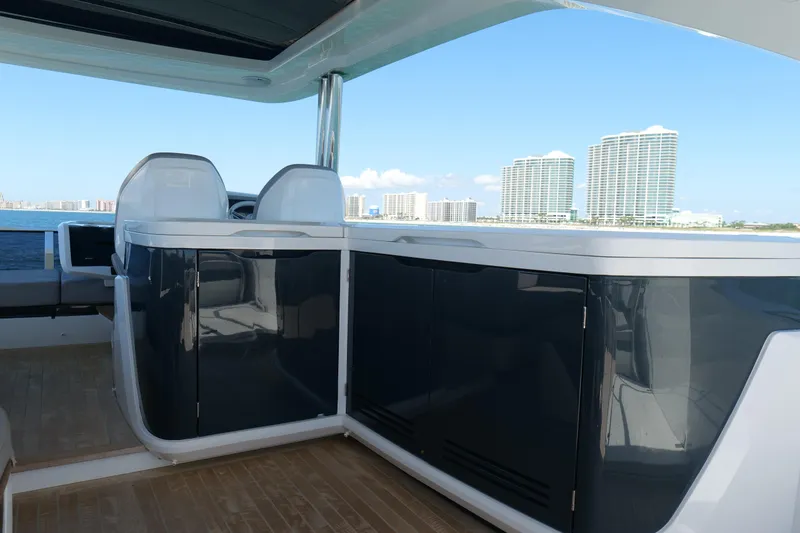 Slide: The Image of 2022 Pearl 62 yacht interior with modern design, overlooking coastal skyline. - 48