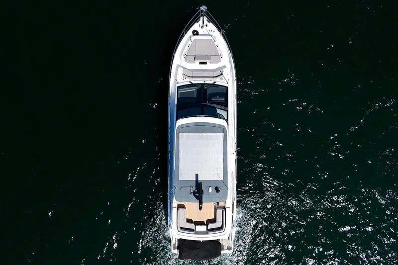 Slide: The Image of Aerial view of 2022 Pearl 62 yacht cruising on dark water. - 72