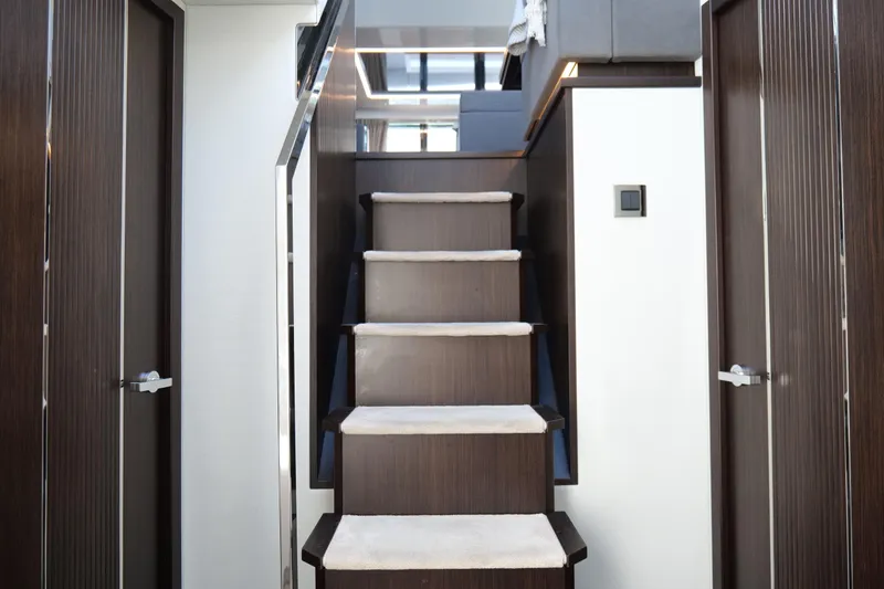 Slide: The Image of Staircase in 2022 Pearl 62 yacht interior with modern wood finish. - 41