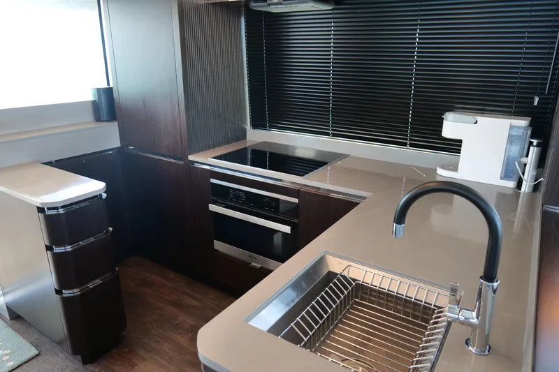 Slide: The Image of Modern kitchen in 2022 Pearl 62 yacht with sleek countertops and appliances. - 13