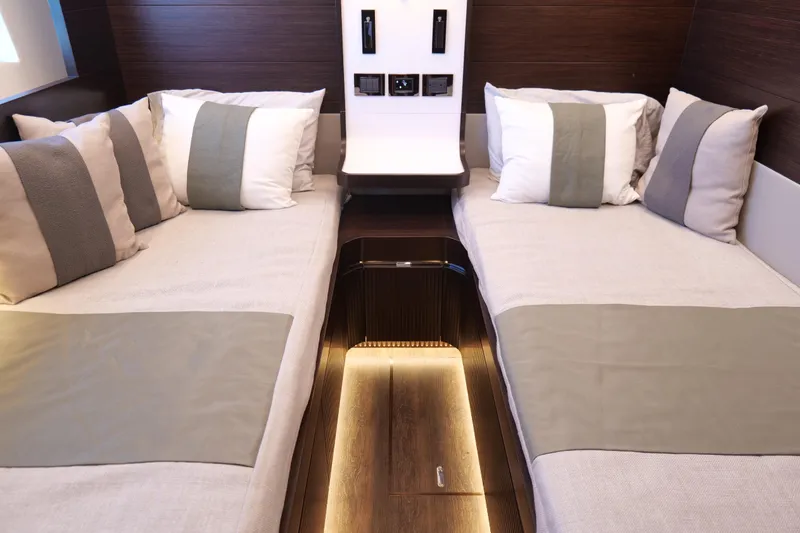 Slide: The Image of Luxurious twin cabin interior in 2022 Pearl 62 yacht, featuring elegant bedding and modern design. - 40