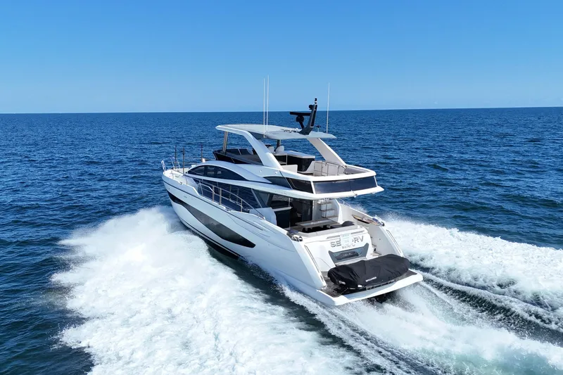 Slide: The Image of Luxurious 2022 Pearl 62 yacht cruising on open sea under clear blue sky. - 78