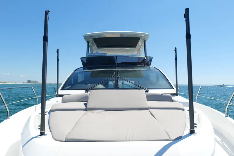 Slide: The Image of 2022 Pearl 62 yacht on open water, featuring sleek design and spacious deck. - 63
