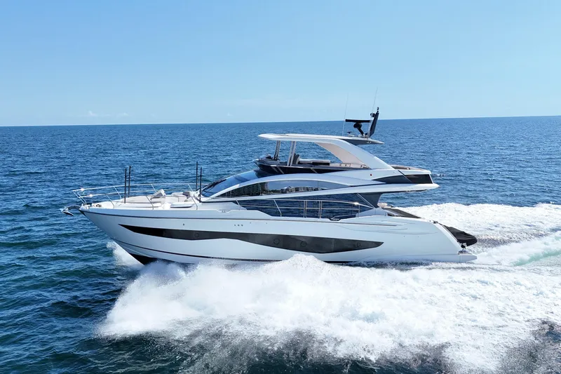 Slide: The Image of Luxurious 2022 Pearl 62 yacht cruising on open sea under clear blue sky. - 77