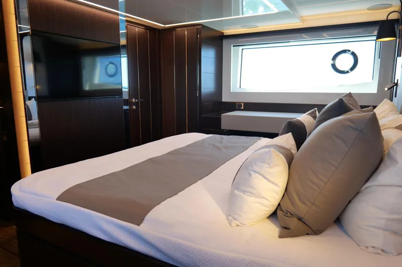 Slide: The Image of Luxurious bedroom interior on 2022 Pearl 62 yacht, featuring elegant bedding and modern design. - 26
