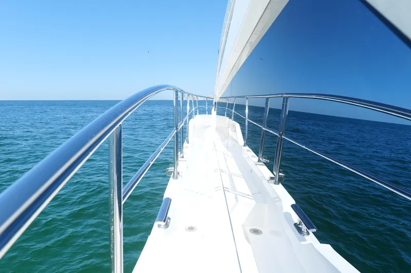 Slide: The Image of Side view of 2022 Pearl 62 yacht on open sea under clear blue sky. - 59