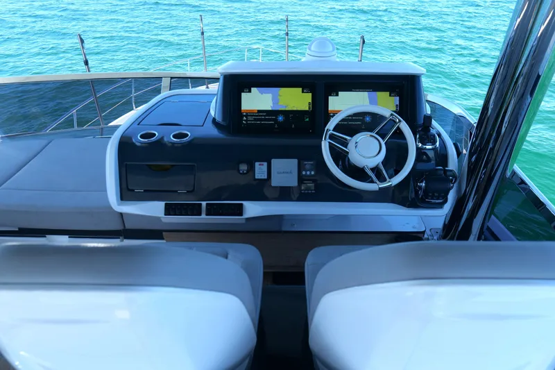 Slide: The Image of Helm of 2022 Pearl 62 yacht with dual navigation screens and steering wheel. - 51