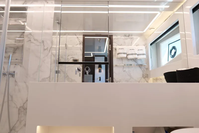 Slide: The Image of Luxurious yacht bathroom with marble walls, modern fixtures, and elegant lighting, Pearl 62, 2022 model. - 28