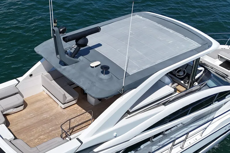 Slide: The Image of Modern 2022 Pearl 62 yacht with sleek design and spacious deck on the water. - 55