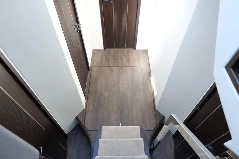 Slide: The Image of Interior view of 2022 Pearl 62 yacht, featuring modern wooden flooring and sleek design. - 32