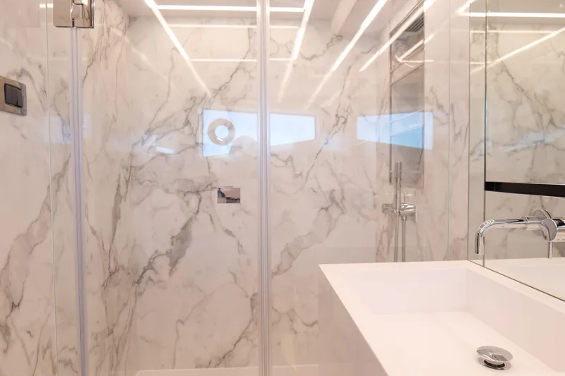 Slide: The Image of Luxurious marble bathroom in 2022 Pearl 62 yacht, featuring modern fixtures and sleek design. - 30