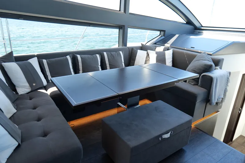 Slide: The Image of Luxurious interior of 2022 Pearl 62 yacht with elegant seating and modern table design. - 19