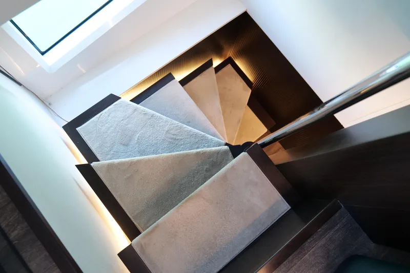 Slide: The Image of Modern staircase with carpeted steps and sleek railing in Pearl 62 yacht, 2022 model. - 22