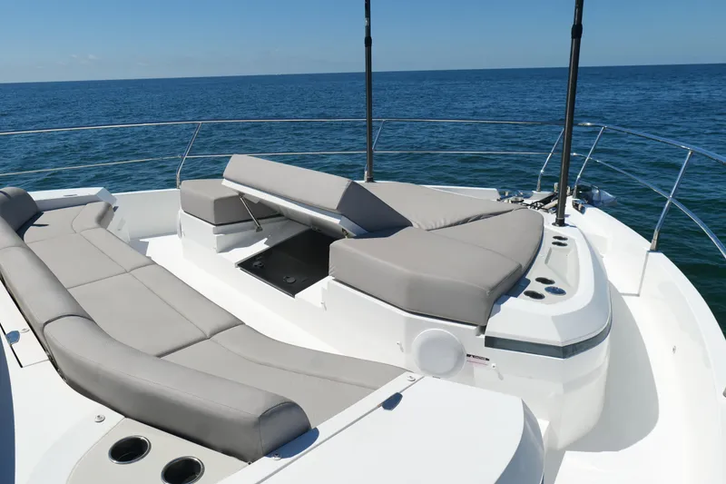 Slide: The Image of Luxurious 2022 Pearl 62 yacht with spacious sunbathing area on open sea. - 62