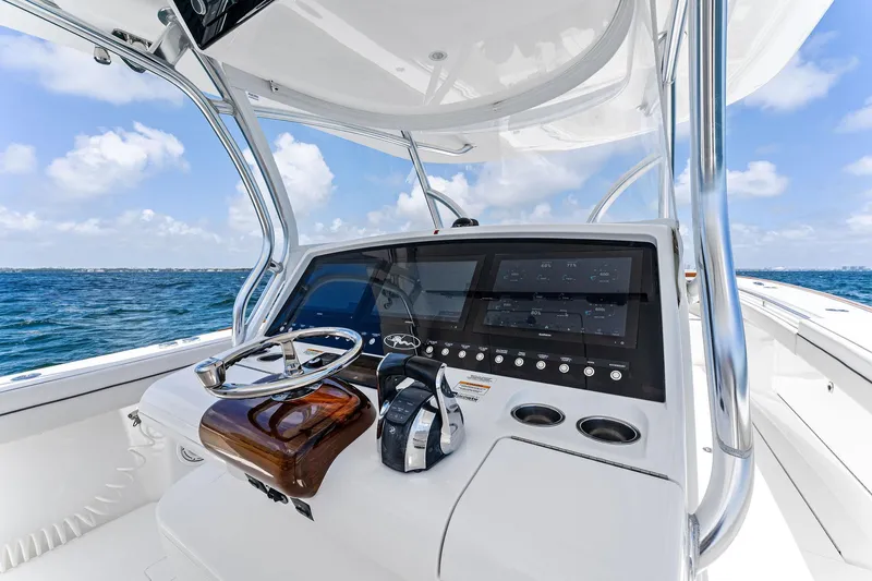 Slide: The Image of 2021 Valhalla Boatworks V-41 helm with modern controls, steering wheel, and ocean view. - 26