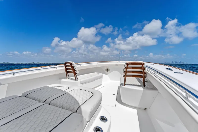 Slide: The Image of 2021 Valhalla Boatworks V-41 deck with seating, under a clear blue sky. - 30