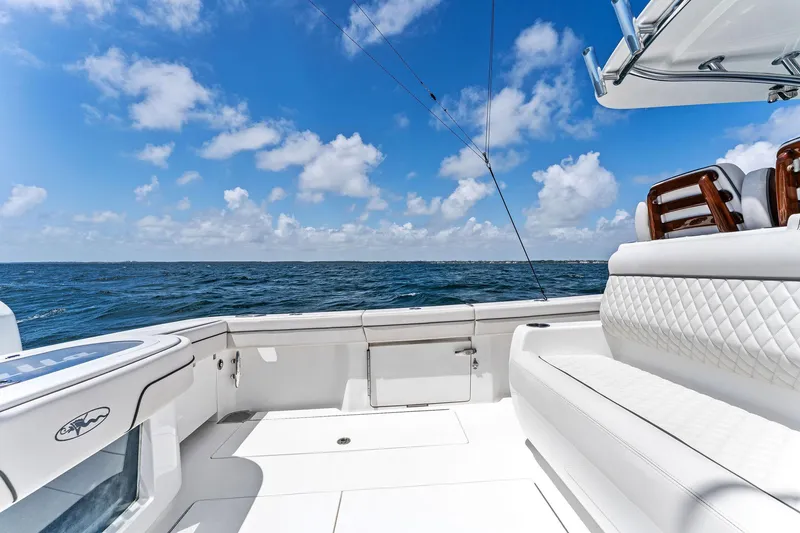 Slide: The Image of 2021 Valhalla Boatworks V-41 deck with ocean view, featuring luxurious seating and clear skies. - 13