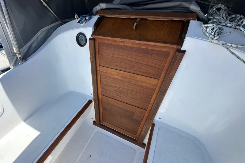 Slide: The Image of Wooden hatch door on 1976 Islander 36 sailboat cockpit, with ropes and seating. - 23
