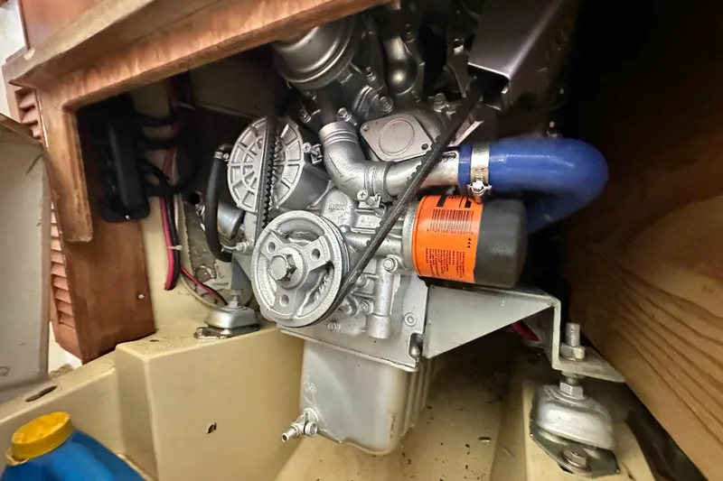 Slide: The Image of Engine compartment of a 1976 Islander 36 sailboat, showcasing mechanical components. - 20