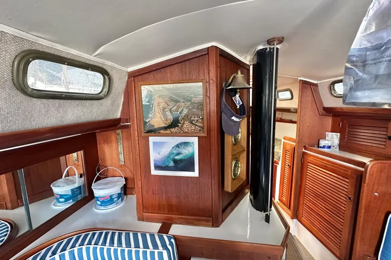 Slide: The Image of Interior of a 1976 Islander 36 sailboat with wood paneling and nautical decor. - 15