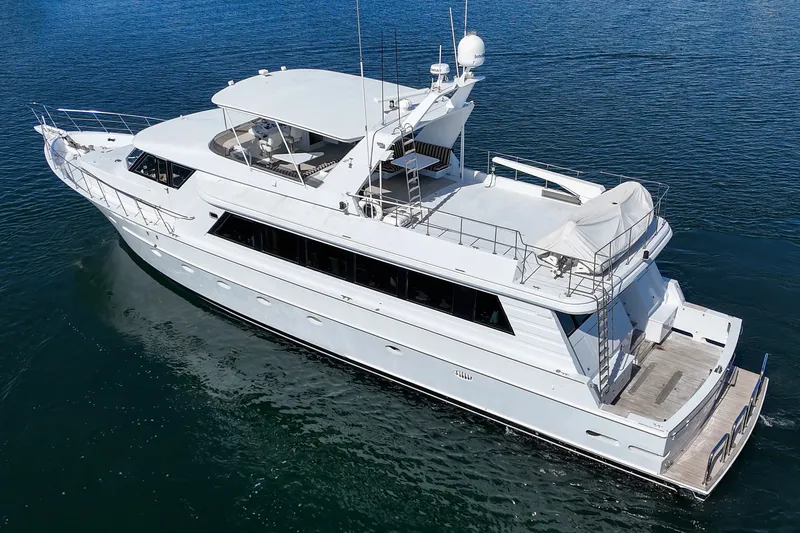 Slide: The Image of A luxurious white yacht floating on calm water, featuring a spacious deck and modern antennas. - 7