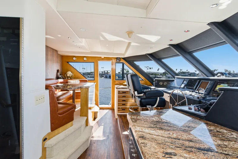Slide: The Image of Interior of a luxury yacht with leather seating, wood floors, and large windows overlooking the water. - 26