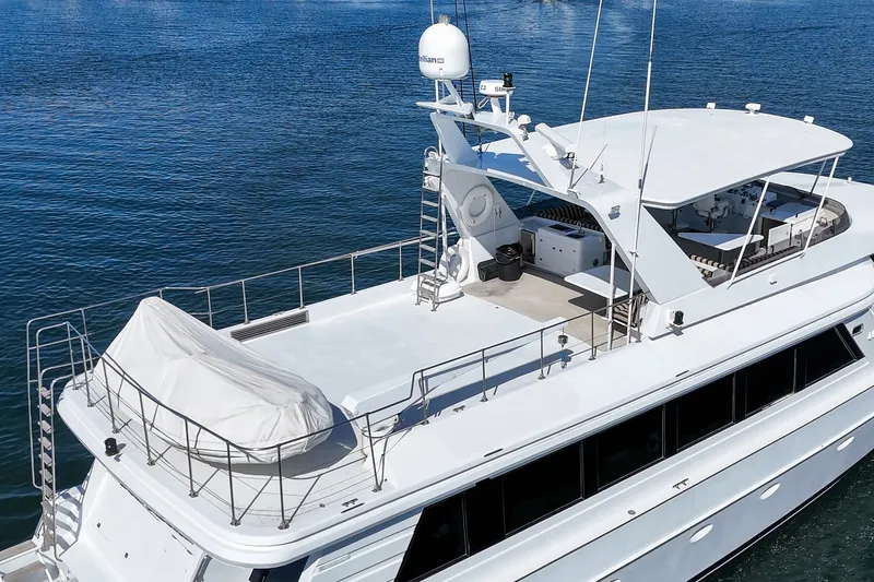 Slide: The Image of The 1990 Westport Crescent features a spacious deck with cover and radar on calm waters. - 11