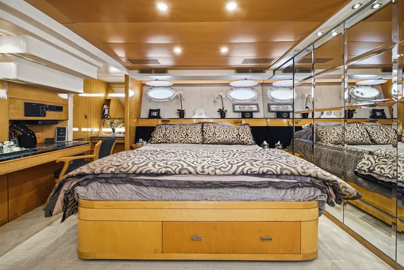 Slide: The Image of Luxurious yacht bedroom with a large bed, mirrored wall, and elegant lighting. - 41